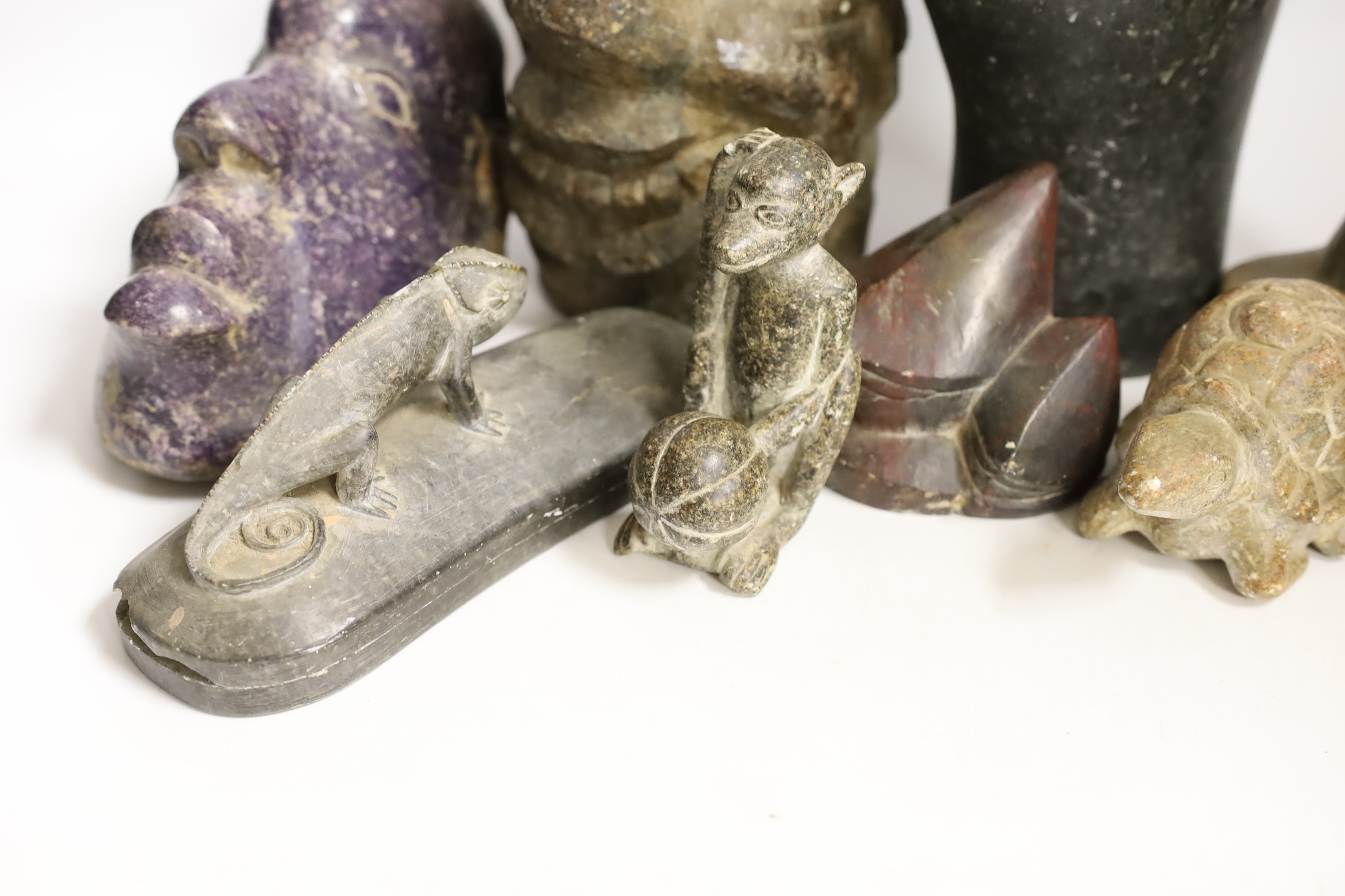 Ten Shona stone carvings, 1960s-70s, including three heads, the first in purple Lepodolite signed Conrad Nyagwande, one signed Amani the other initialled NM, a tortoise, a monkey, a gecko box and abstract sculpture forms